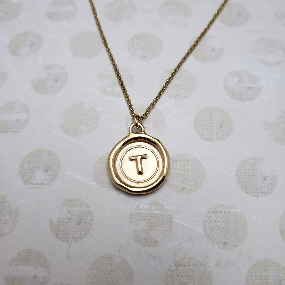 Letter T in gold vermeil