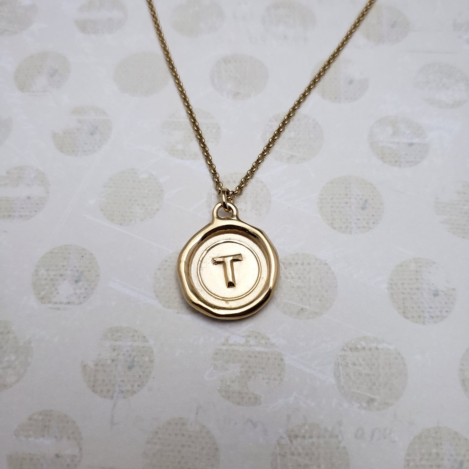 Letter T in gold vermeil