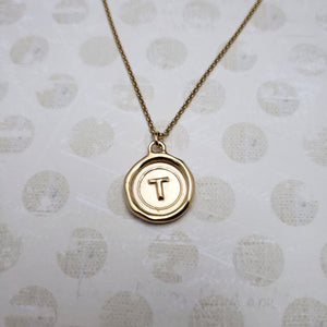 Letter T in gold vermeil