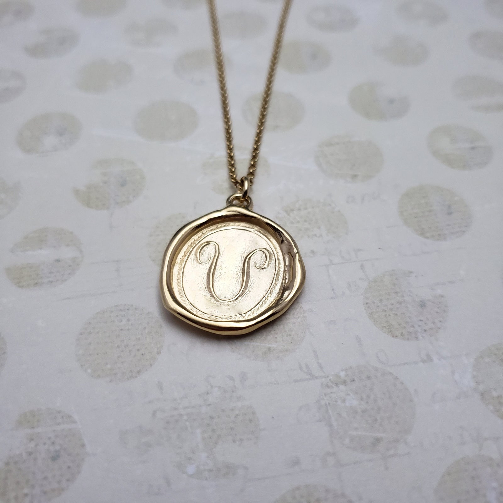 Letter U in gold vermeil