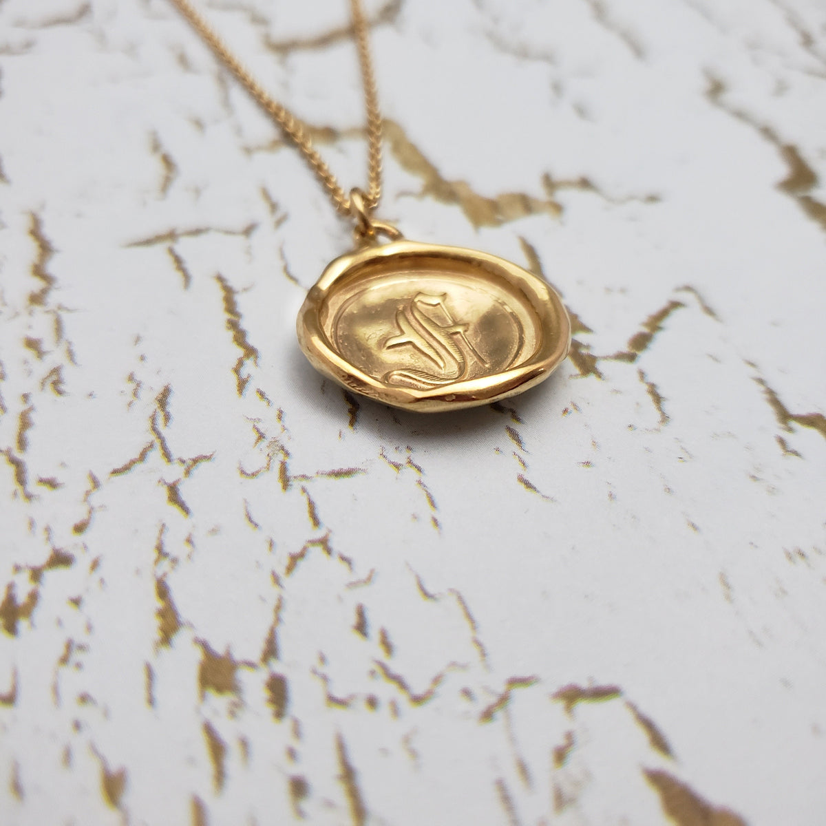 Letter F in gold vermeil