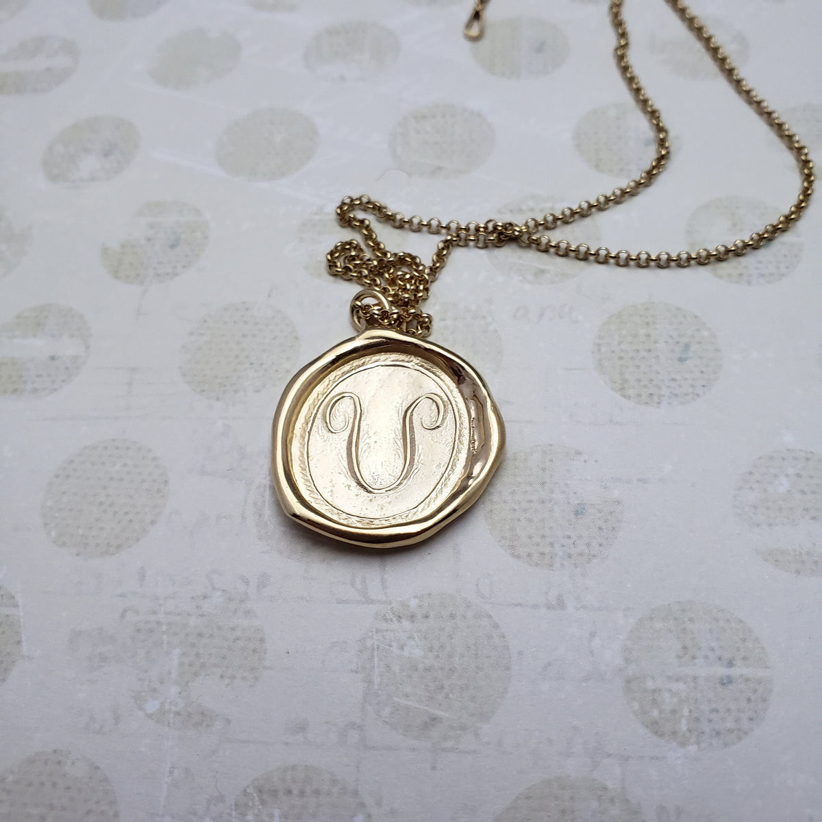 Letter U in gold vermeil