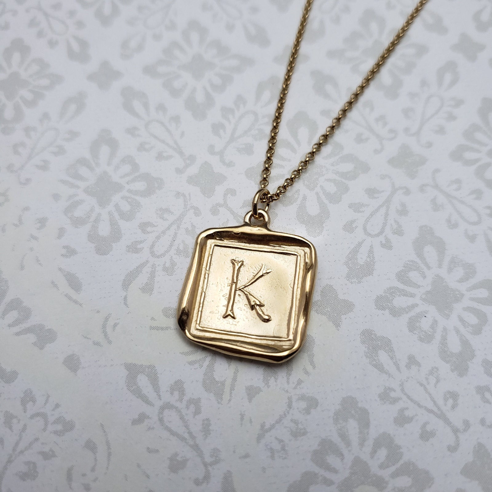 Letter K in gold vermeil