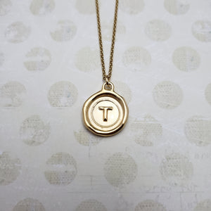 Letter T in gold vermeil