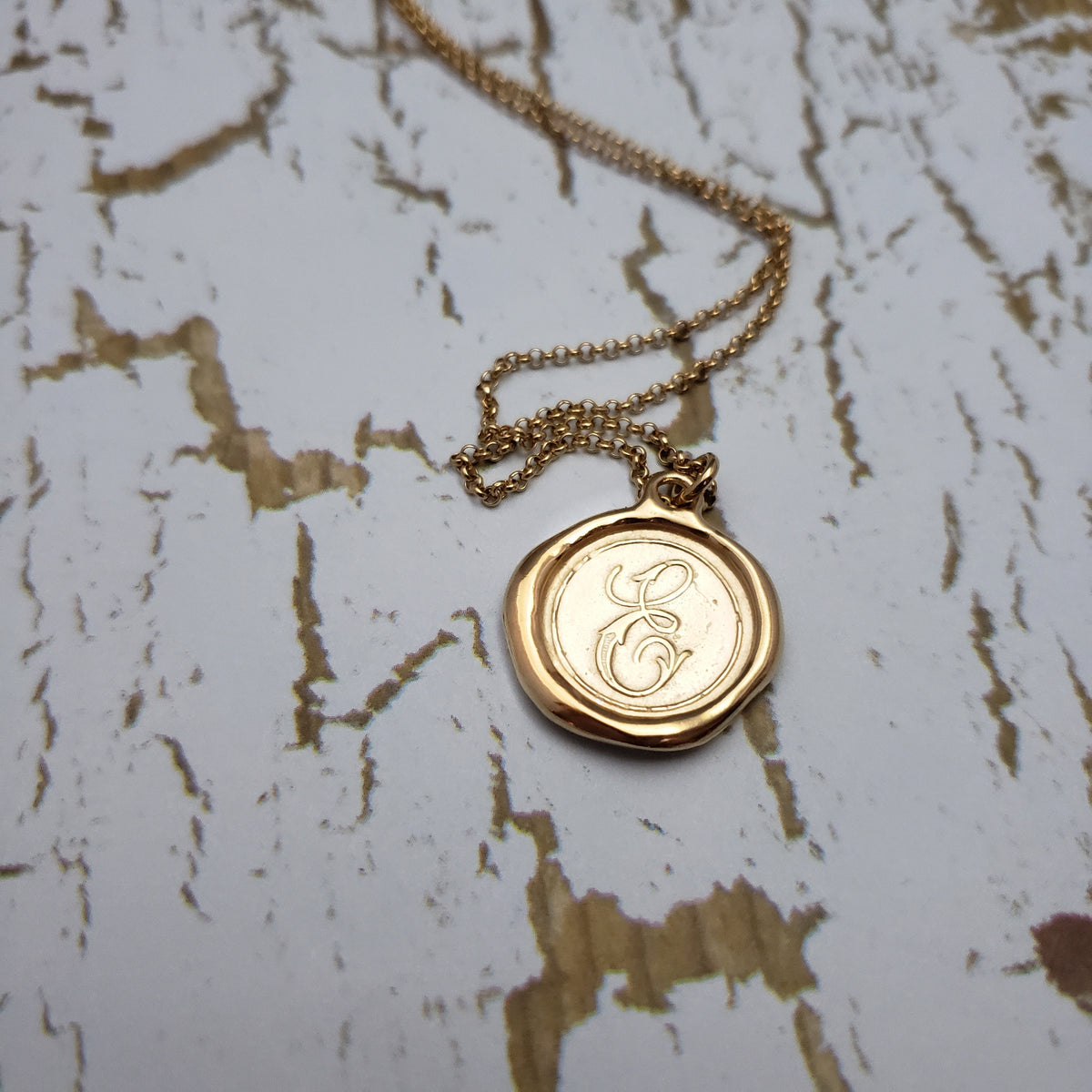 Letter E in gold vermeil
