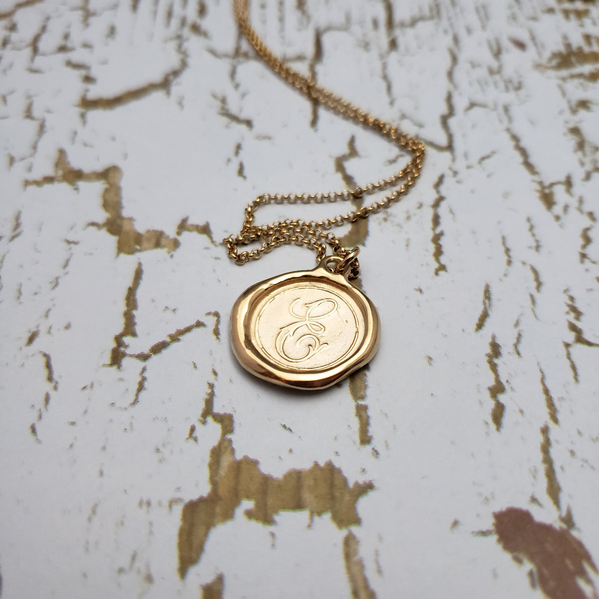 Letter E in gold vermeil