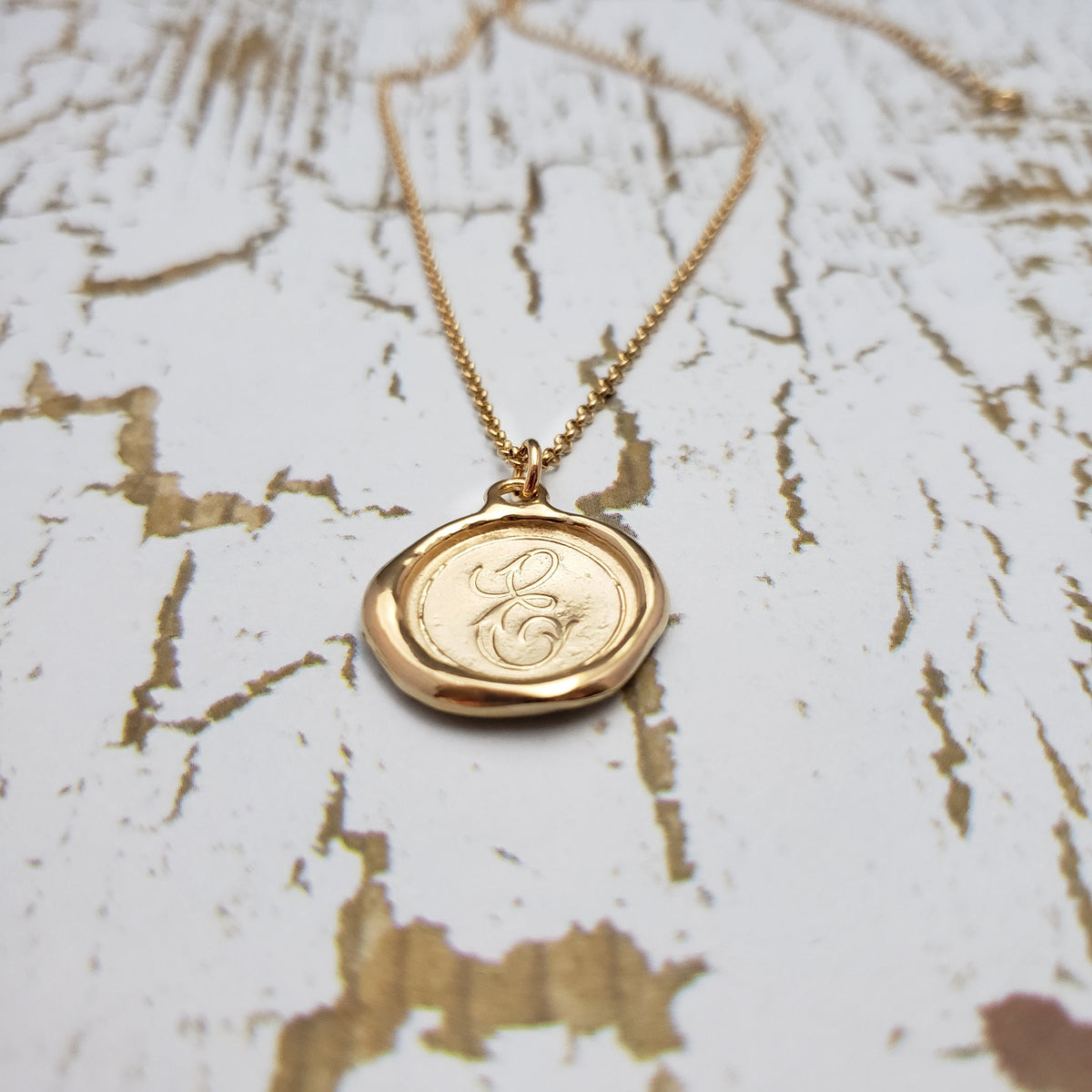 Letter E in gold vermeil