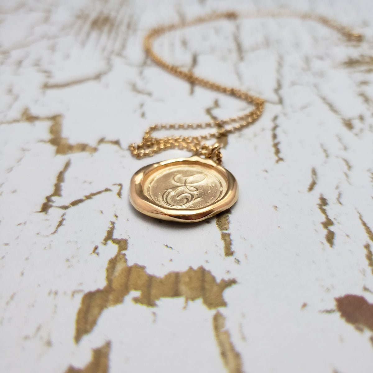 Letter E in gold vermeil