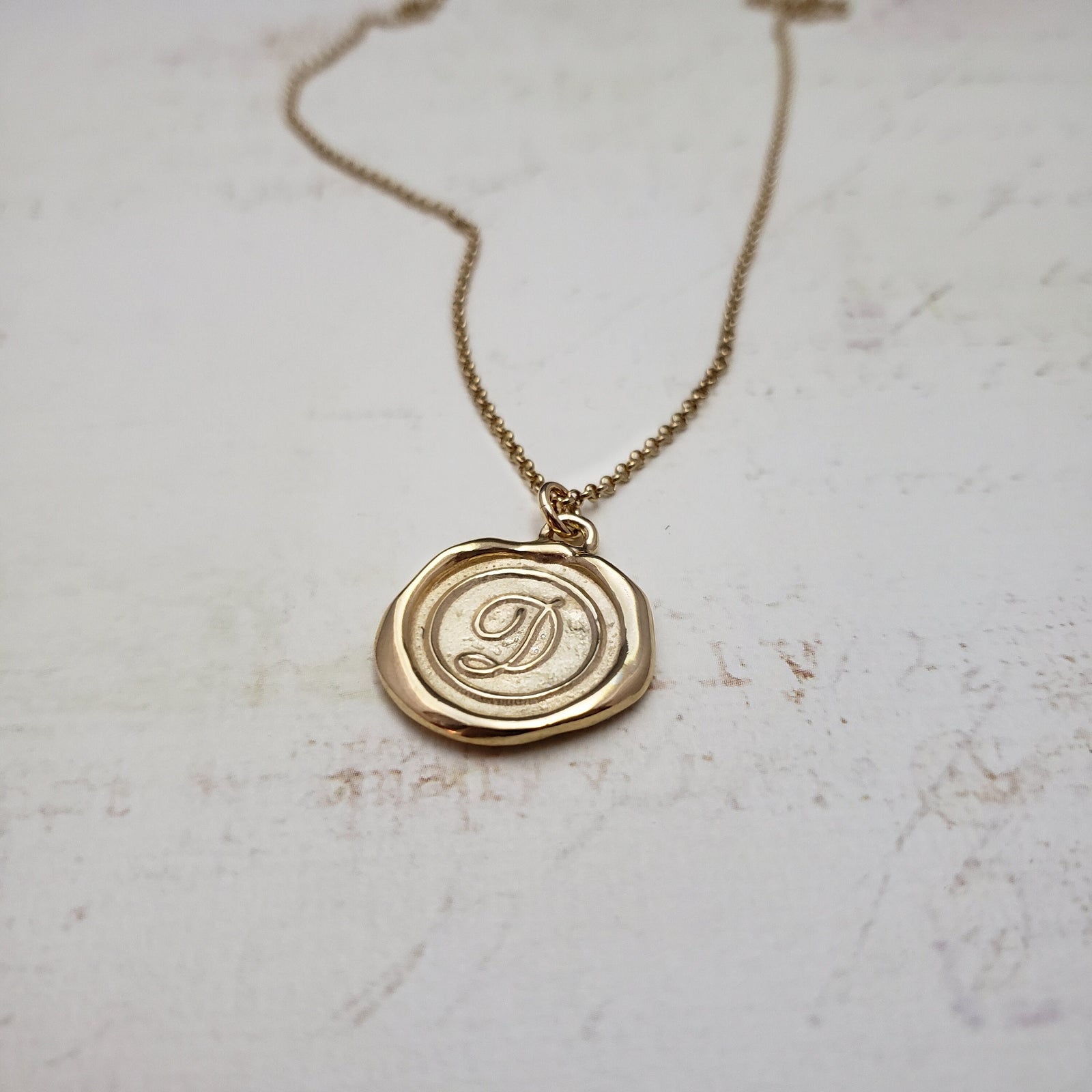 Letter D in gold vermeil
