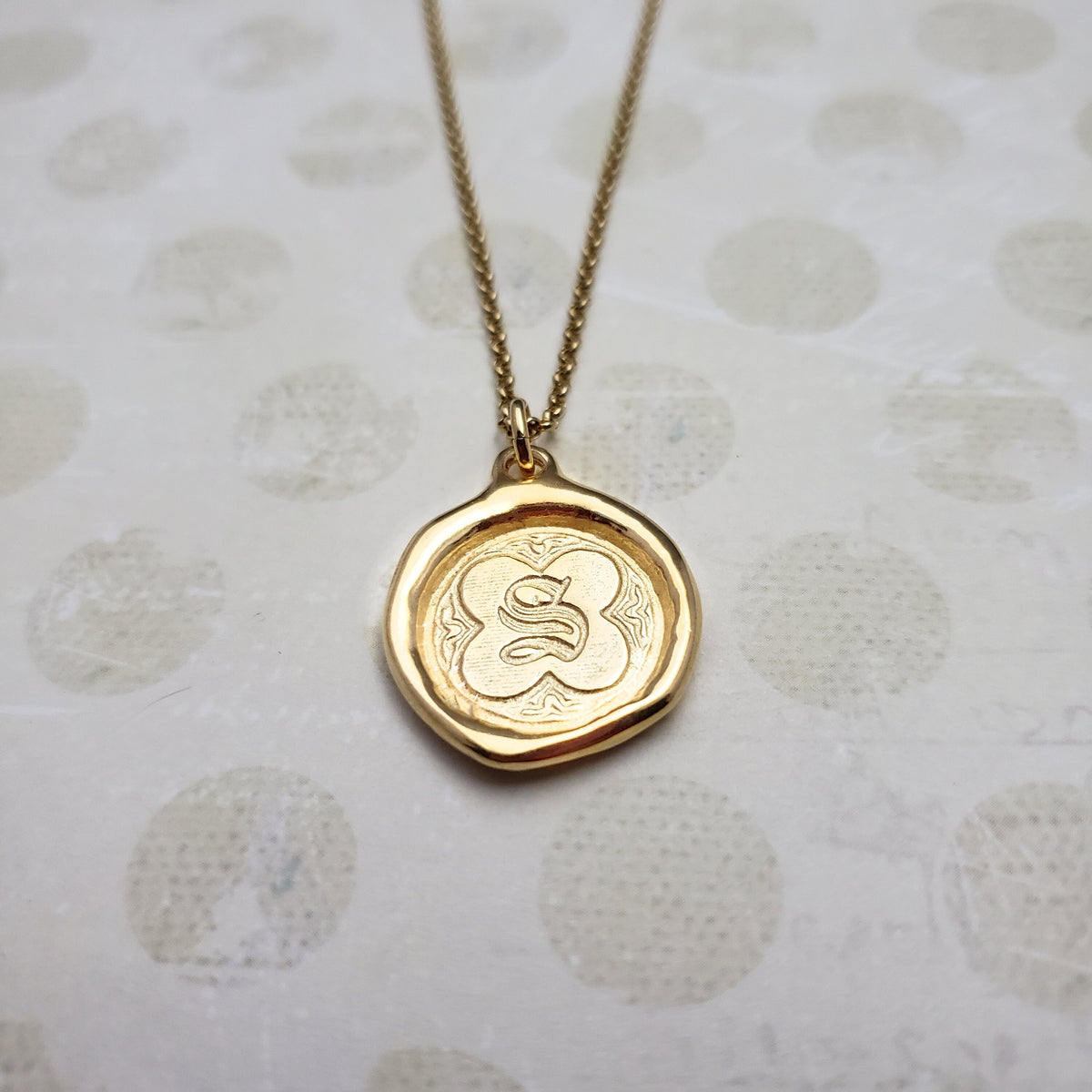 Letter S in gold vermeil