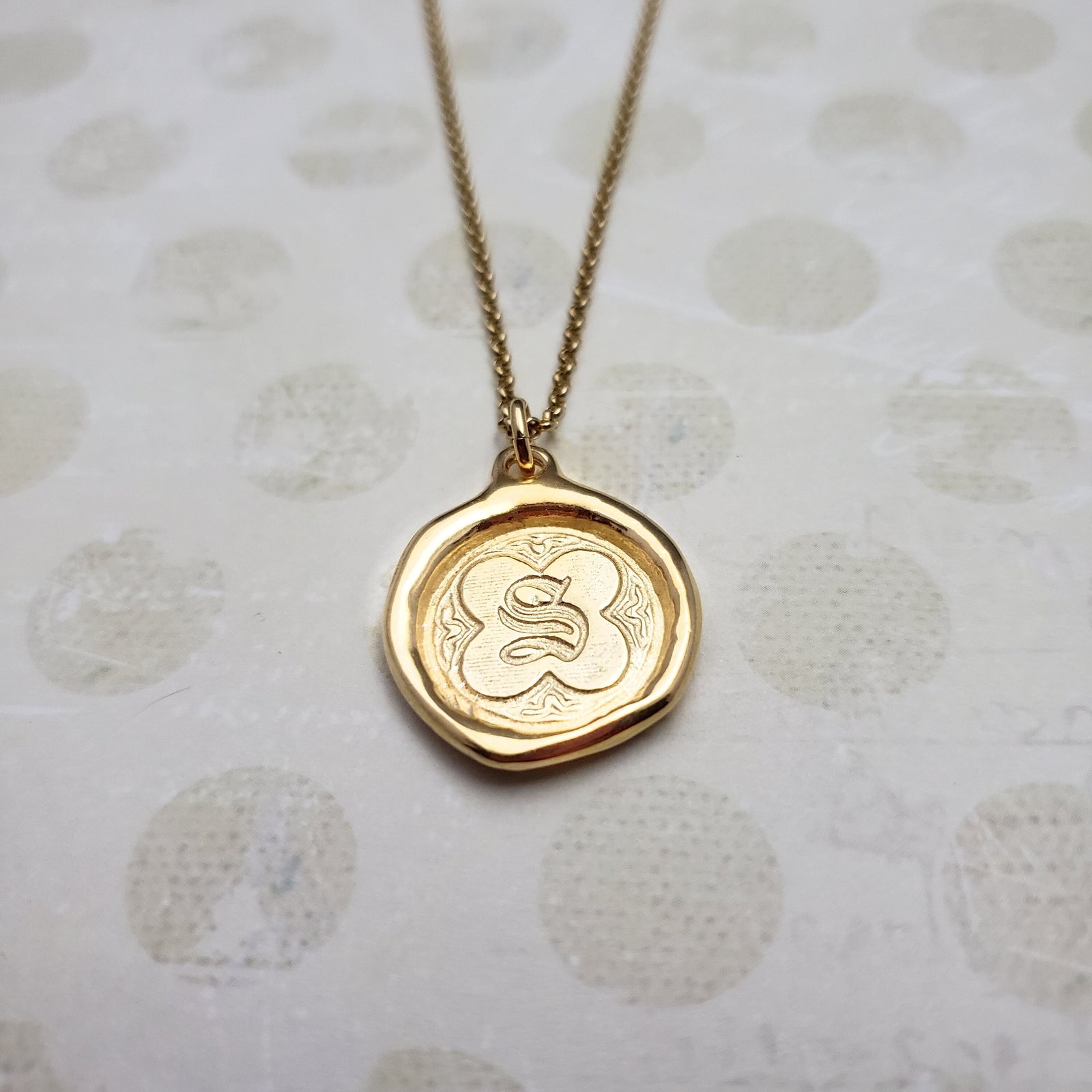 Letter S in gold vermeil