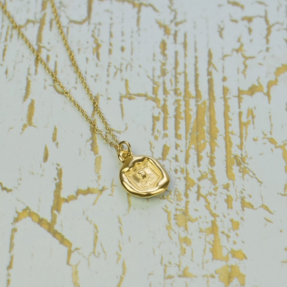 Skull and Crossbones - Thus the end in Gold Vermeil