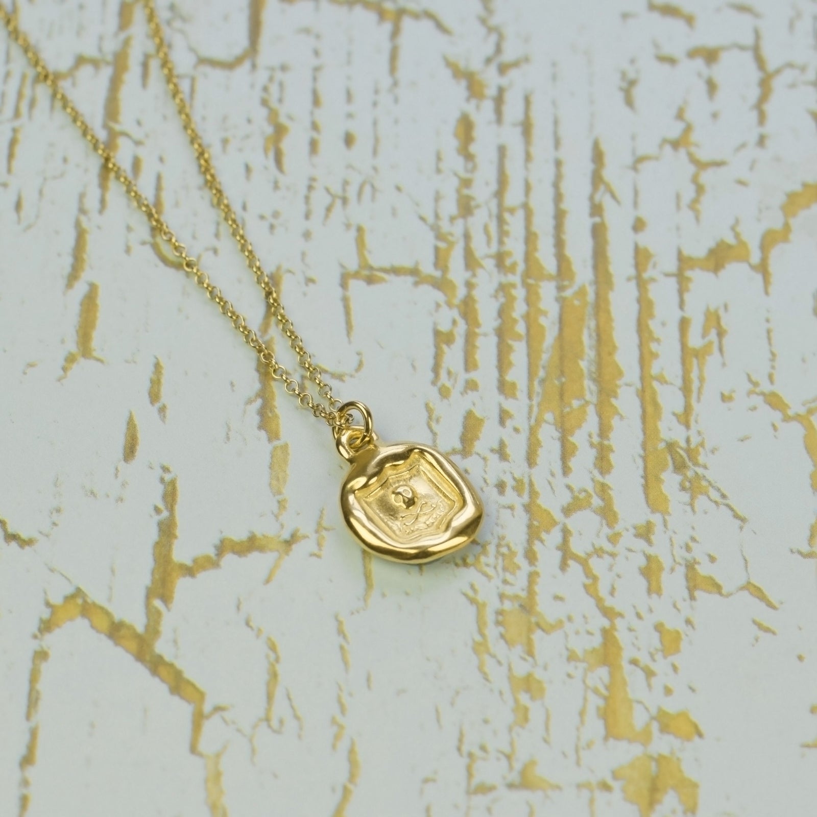 Skull and Crossbones - Thus the end in Gold Vermeil